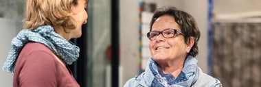 Zwei Personen sprechen lachend in der Stadtbibliothek Winterthur.