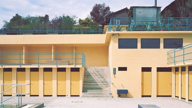 Schwimmbad Wolfensberg mit Blick auf die gelben Umkleidekabinen