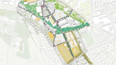 Stadtplan mit Grünflächen und Gebäuden.