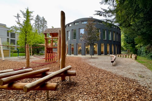Spielplatz mit Holzklettergerüsten neben dem ehemaligen Swica-Gebäude