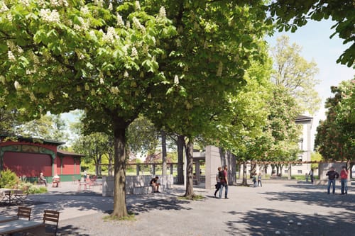 Menschen spazieren unter Bäumen in einem sonnigen Park.